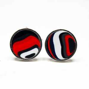 Round earrings with abstract red, black, white design.