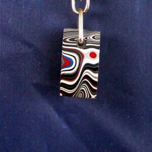 Colorful abstract keychain on blue background.
