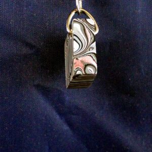 Metal keychain with intricate swirl pattern.