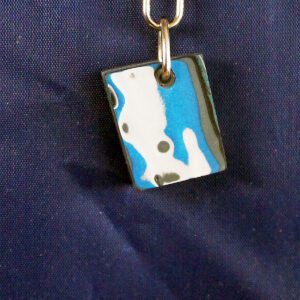 Abstract pendant with blue and white design.