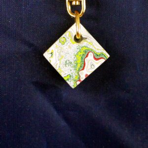 Colorful square pendant on a dark background.