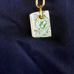 Decorative pendant with swirling green patterns.