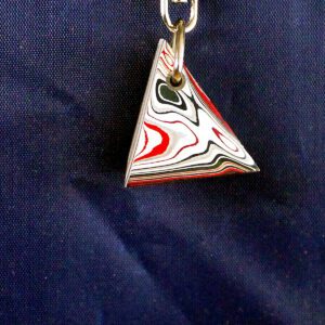 Colorful triangular pendant with swirling patterns.