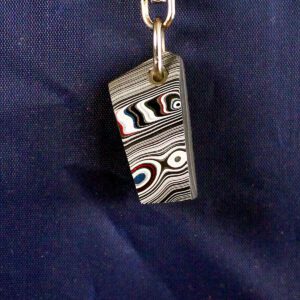 Colorful abstract pendant on a blue background.
