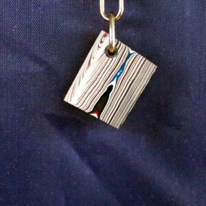 Colorful abstract pendant on a keychain.