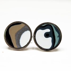 Abstract circular earrings with swirling patterns.