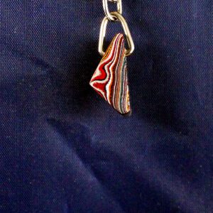 Colorful pendant hanging on a metal chain.