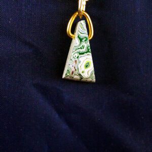 Triangular stone pendant with gold ring.