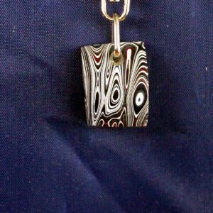 Pendant with black and white swirl pattern.