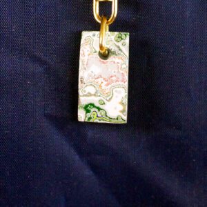 Abstract pendant against dark blue background.