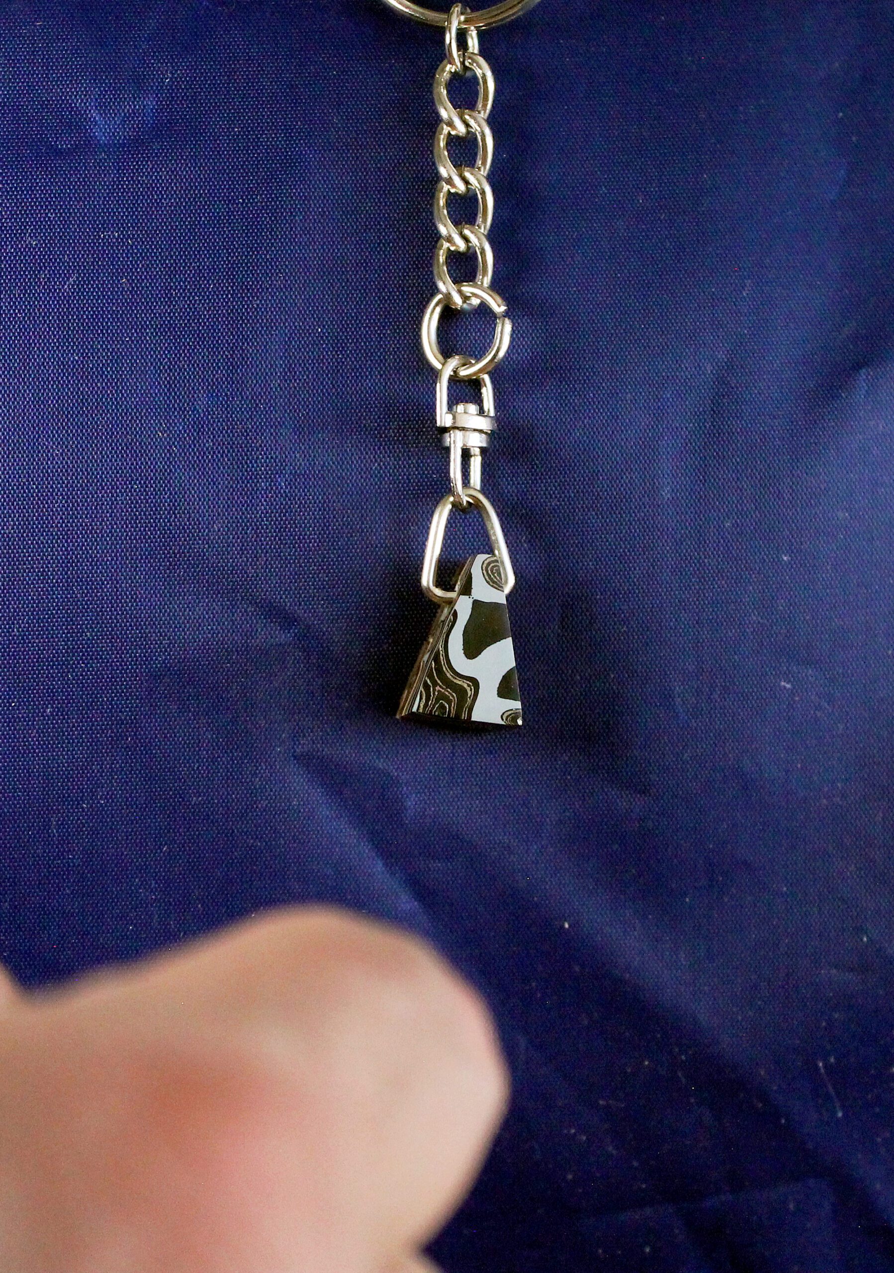 Keychain with patterned metal charm.