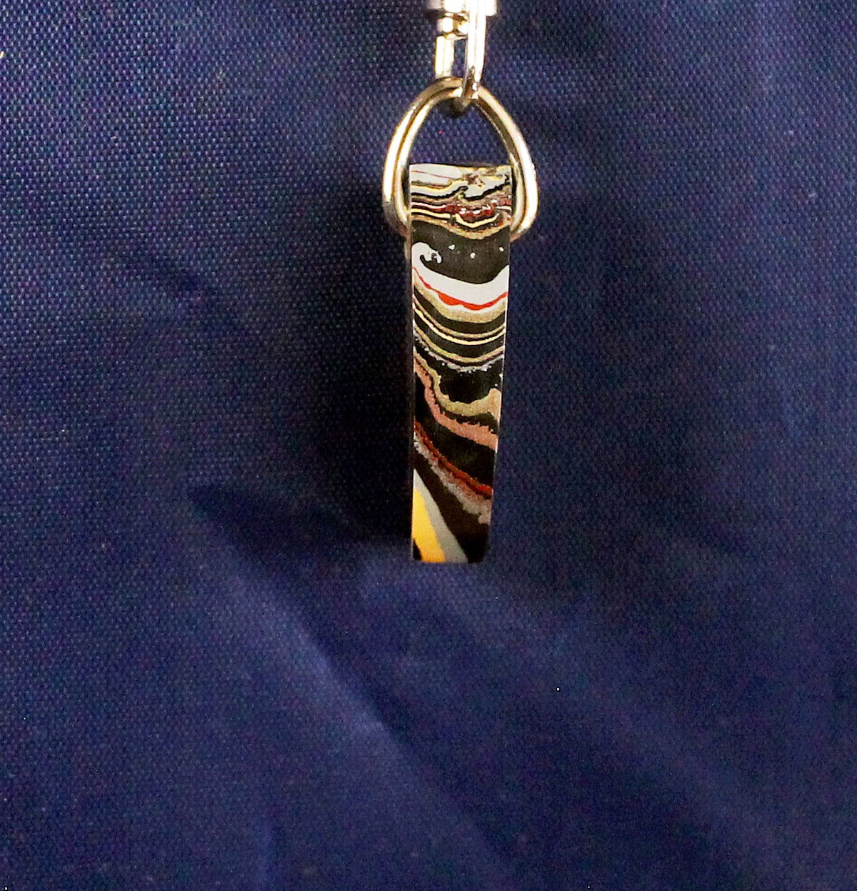 Striped keychain on a blue background.