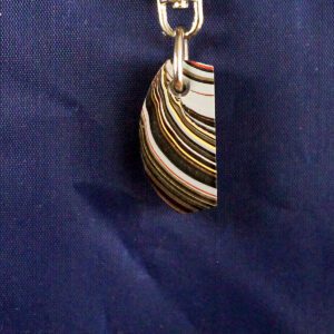 Colorful striped pendant on blue background.