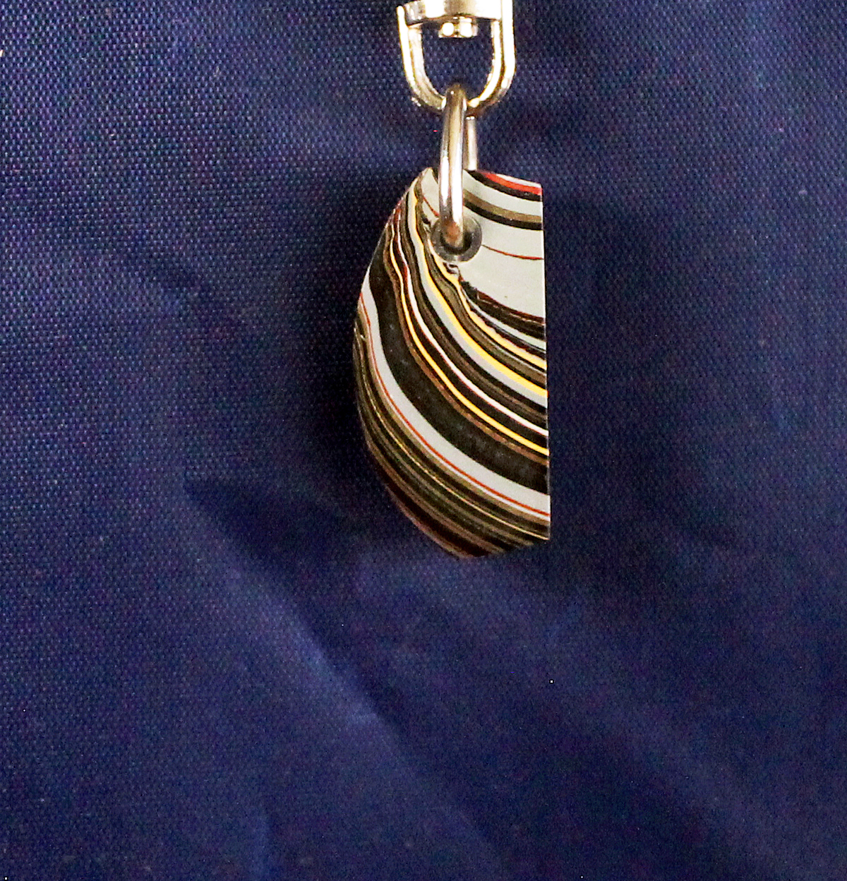 Colorful striped pendant on blue background.