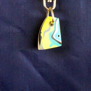 Colorful abstract keychain on dark background.