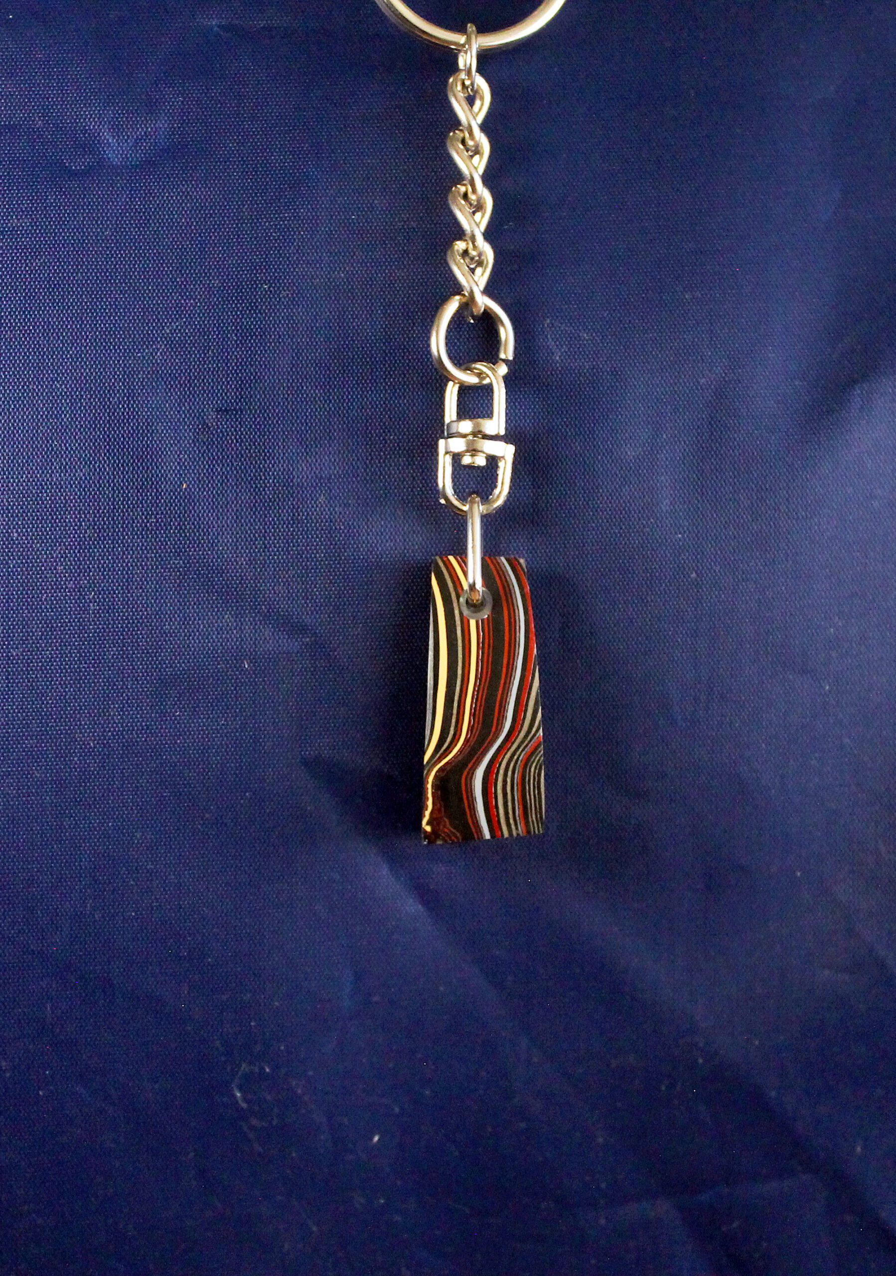 Colorful striped keychain on blue background.