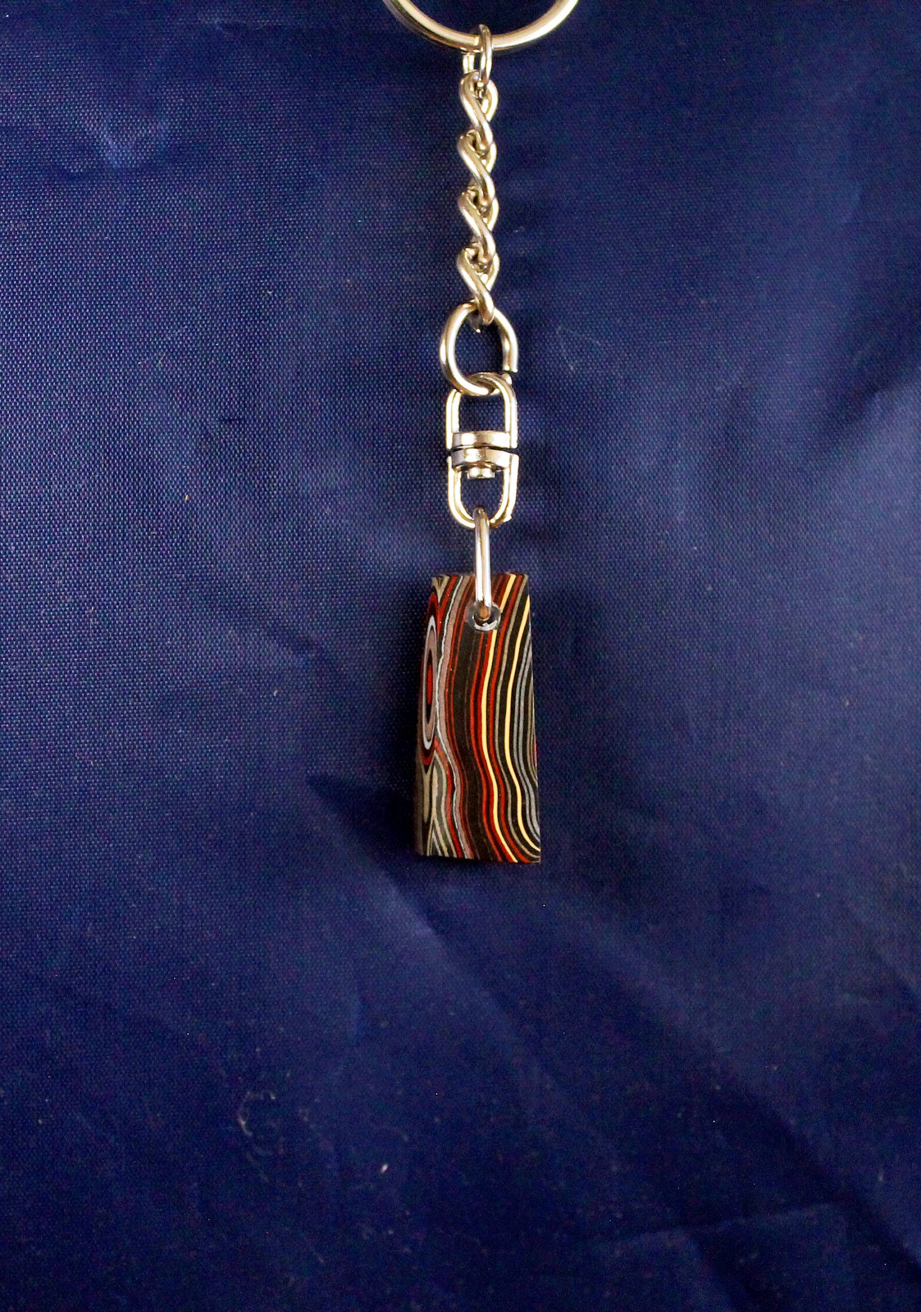 Colorful layered keychain on blue background.