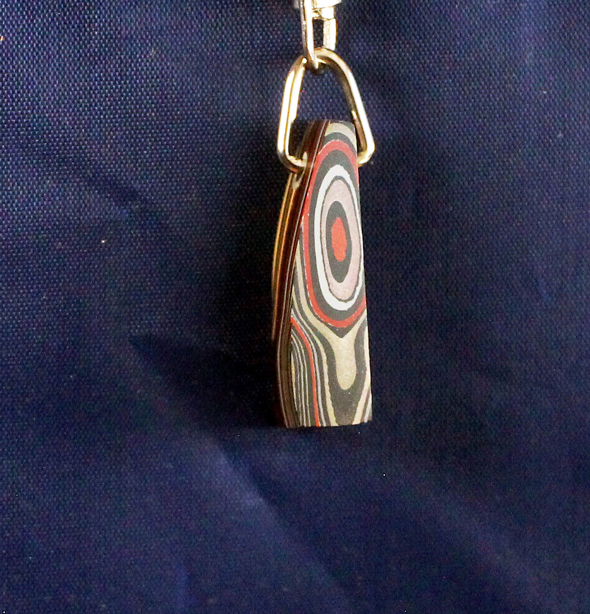 Pendant with colorful concentric circles design.