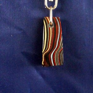 Striped keychain on blue fabric background.
