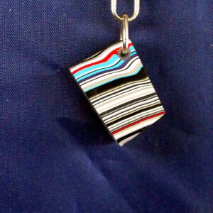 Colorful striped keychain on blue background.
