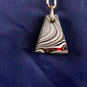 Striped triangular keychain on blue background.
