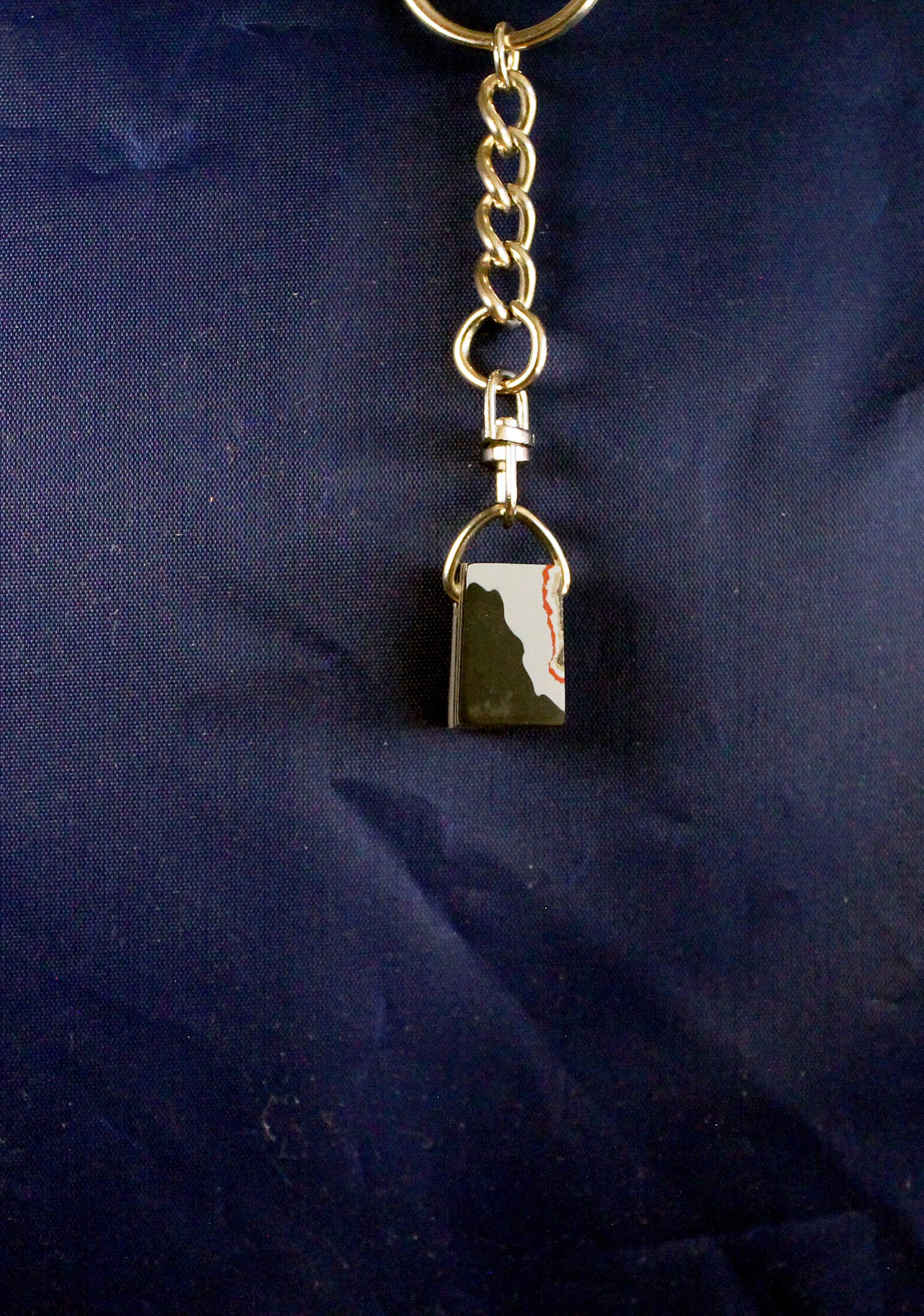 Metal keychain with small padlock charm.