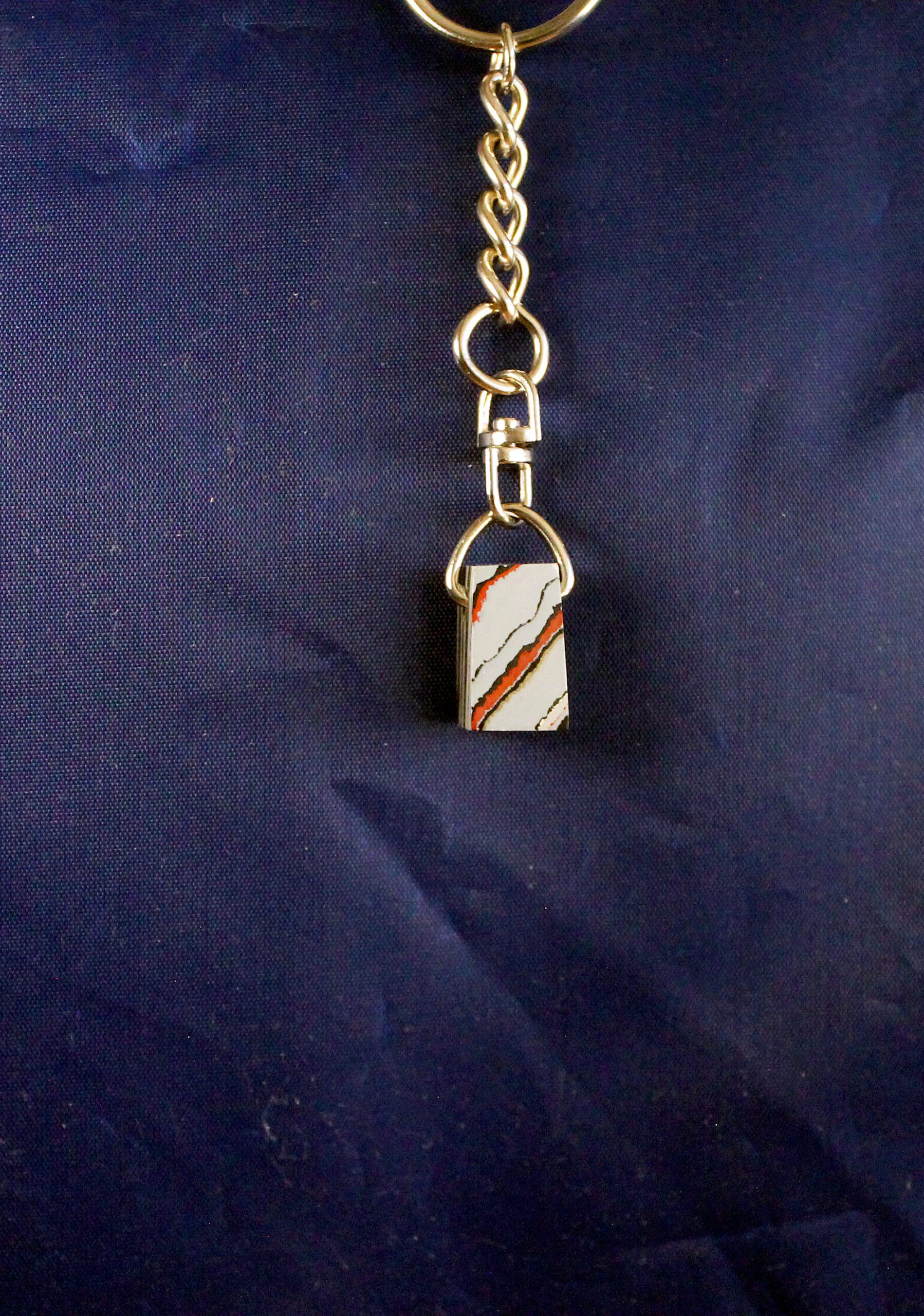 Keychain with rectangular stone pendant.