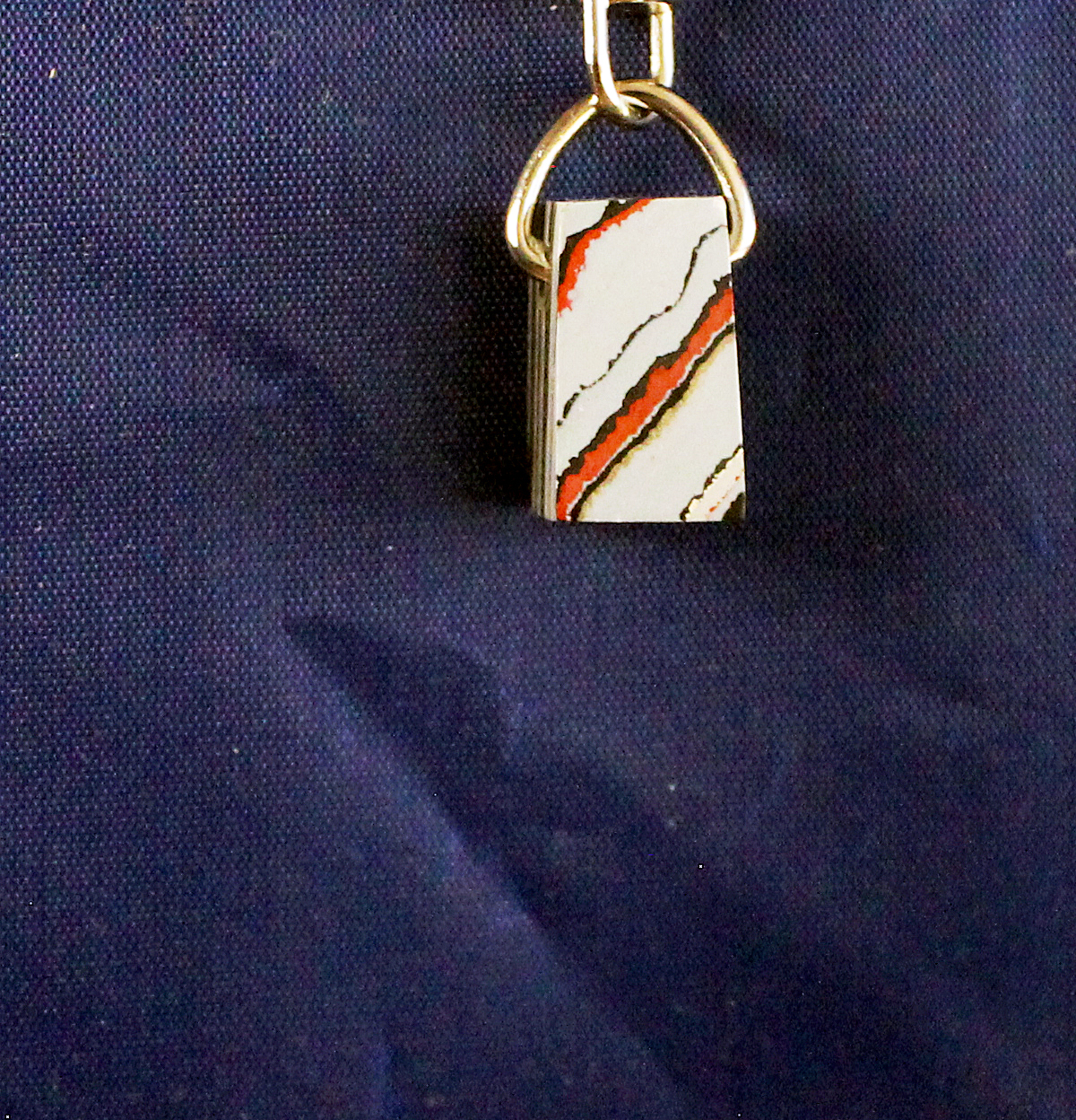 Padlock with abstract design on fabric background.