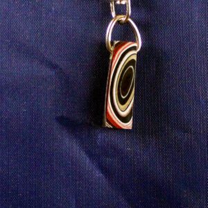 Colorful pendant with concentric circle design.