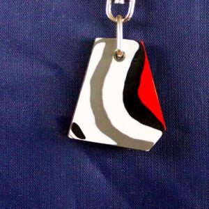 Abstract keychain on dark blue fabric.