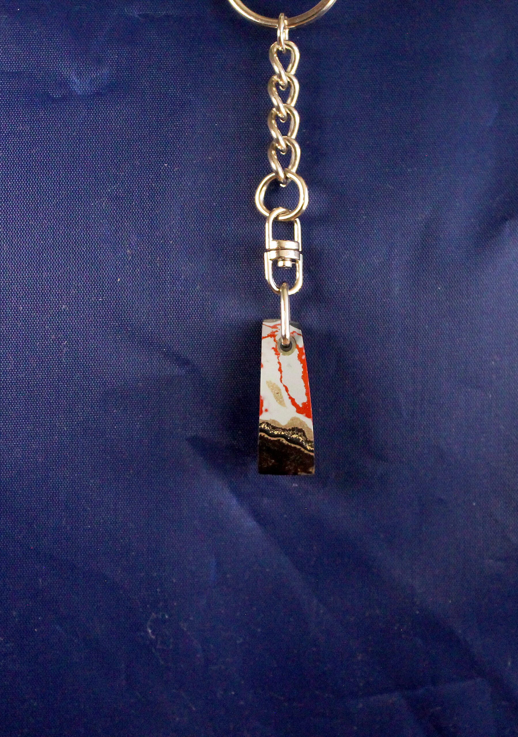 Colorful keychain on blue fabric background.