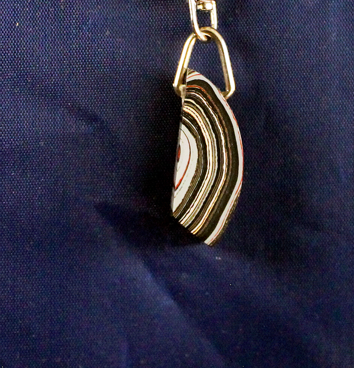 Striped pendant on dark blue background.
