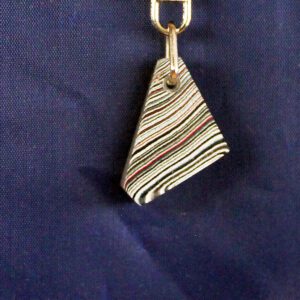 Striped triangular keychain on blue background.