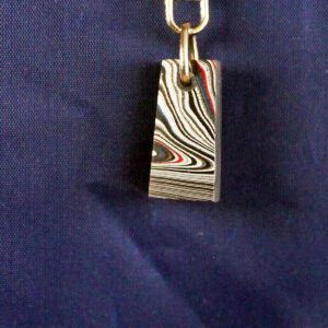 Keychain with striped abstract design on blue.