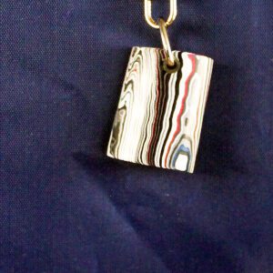Striped keychain on dark blue background.