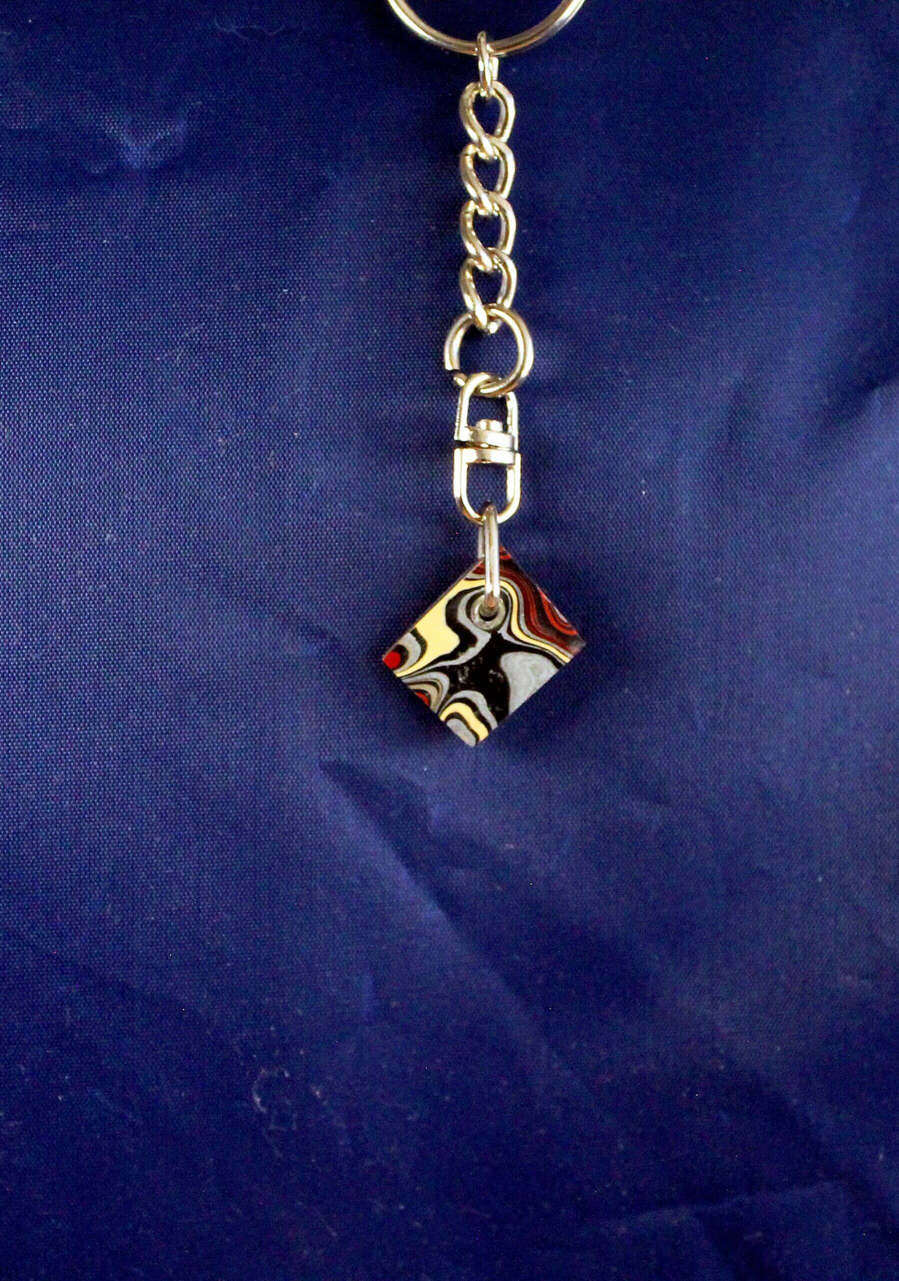 Keychain with colorful square pendant design.
