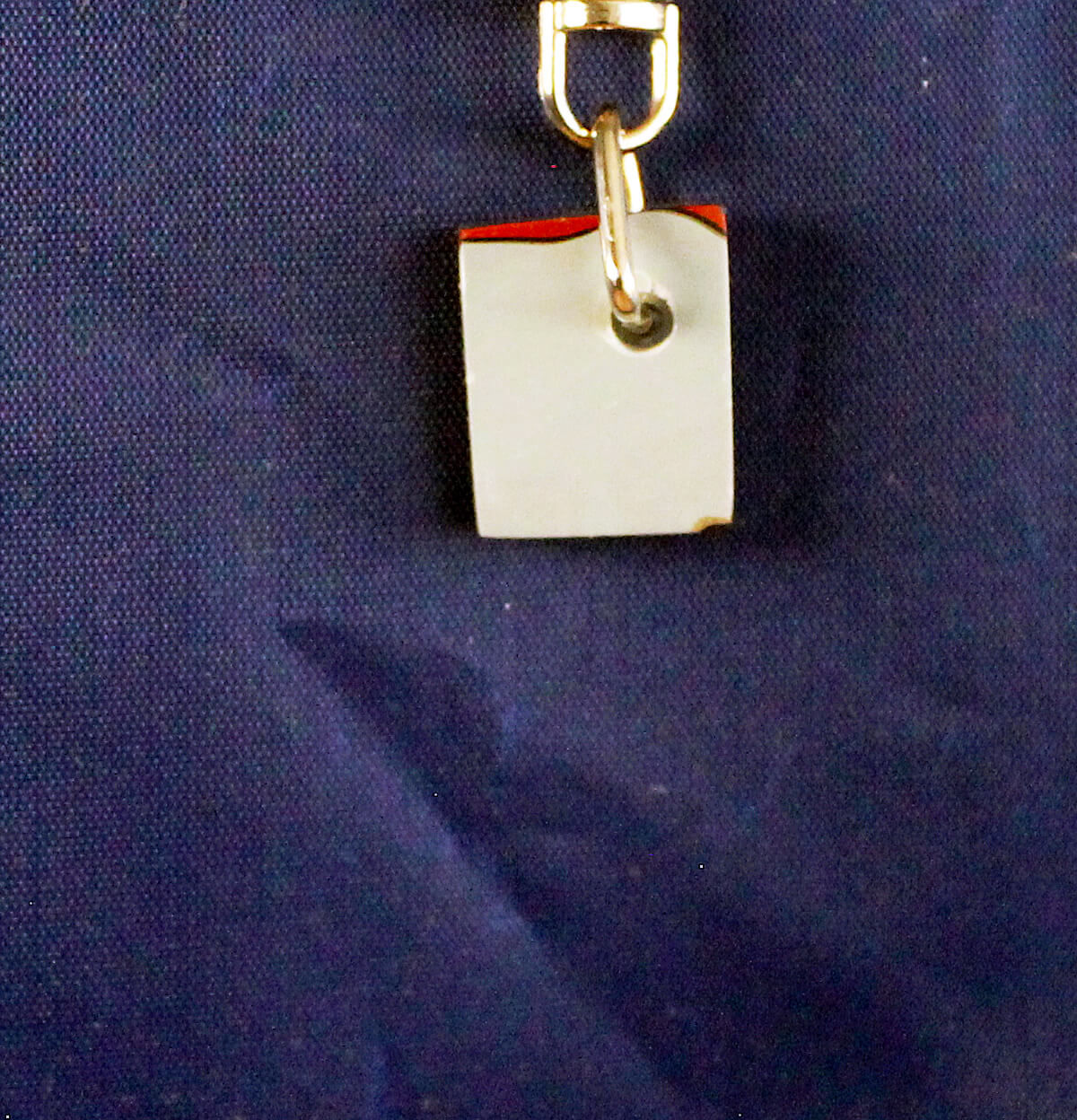 Padlock hanging against a dark background.