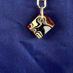 Colorful abstract pendant on blue background.