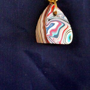 Colorful pendant with swirling patterns on chain.