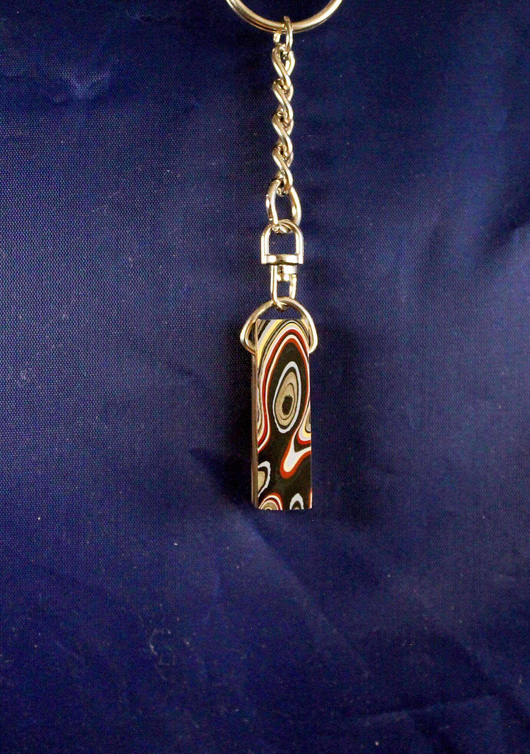 Decorative keychain with abstract pattern design.
