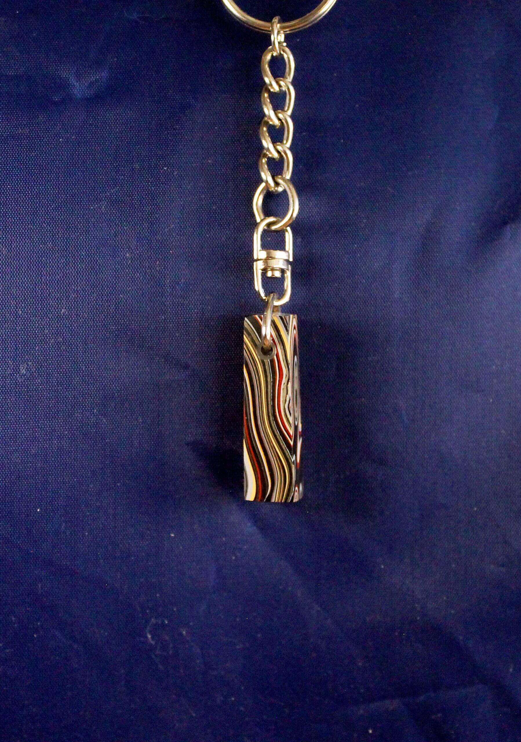Colorful marbled keychain against dark background.