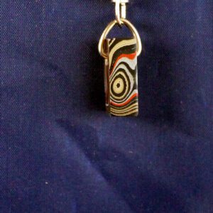 Colorful pendant with abstract swirl design.
