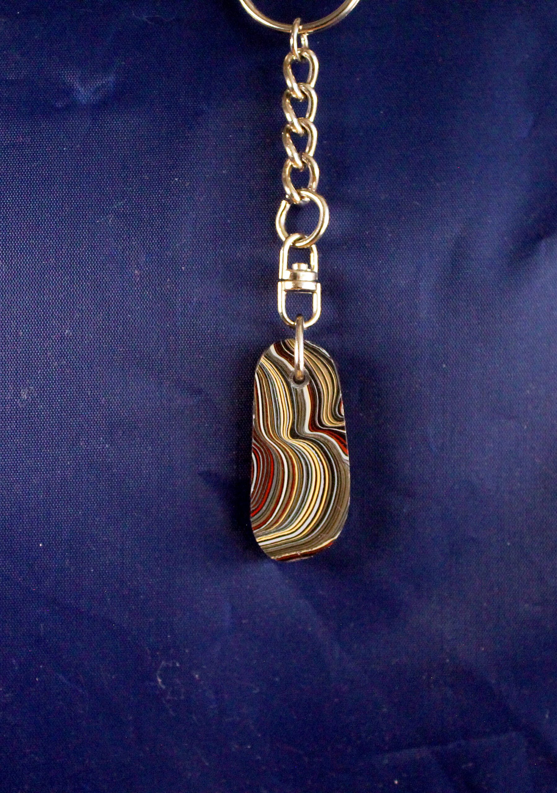 Keychain with colorful layered stone pendant.