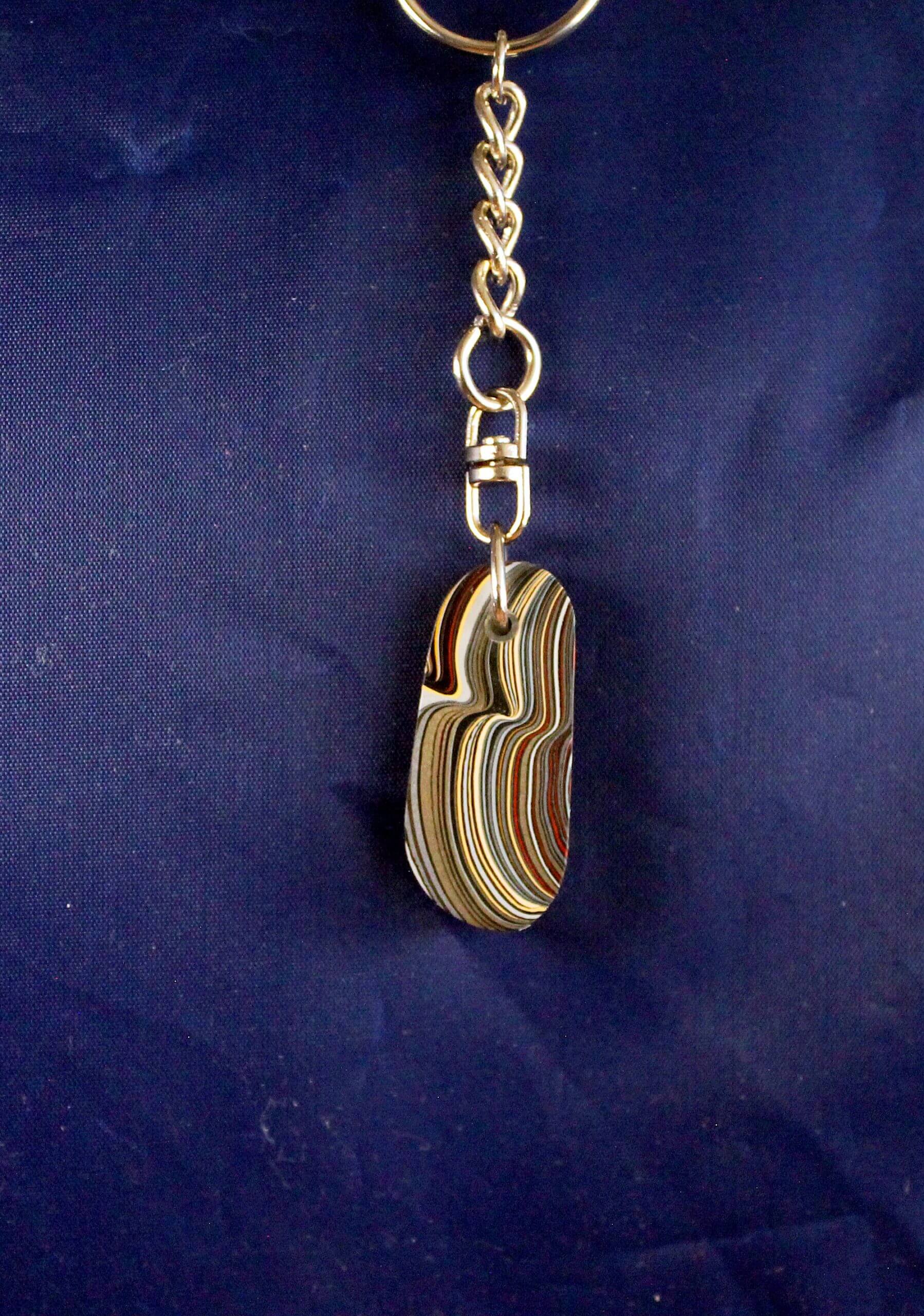 Colorful layered keychain on blue background.