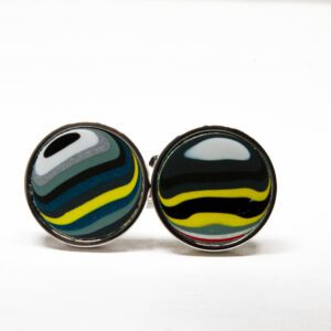 Colorful striped circular cufflinks on white background.