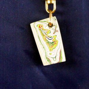 Colorful pendant with abstract pattern on blue.