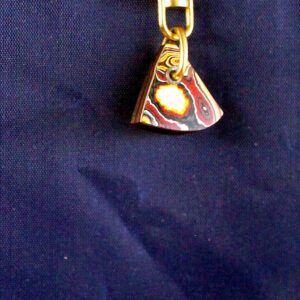 Colorful pendant with abstract design on fabric.