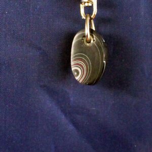 Keychain with a round, striped pendant.