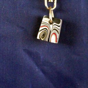 Keychain with colorful, swirled cube pendant.