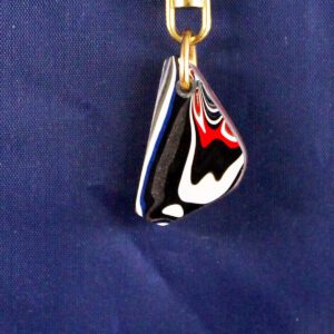Abstract pendant with colorful swirls on blue.